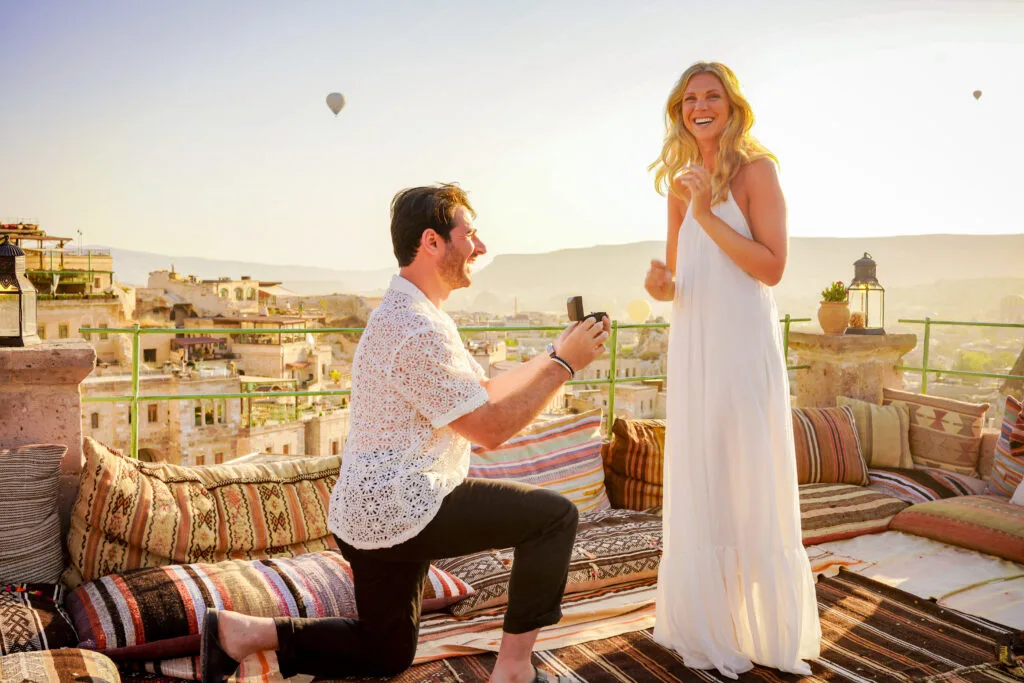 Rooftop Elopement Proposal Photoshoot in Cappadocia with a sunrise and hot air balloons