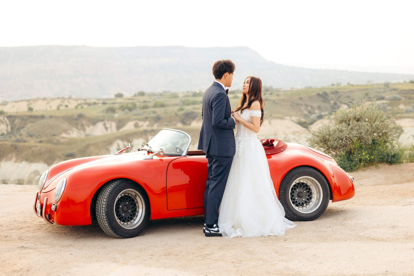 Elopement Photoshoot of a Couple with a Vintage Red Car in Cappadocia scaled